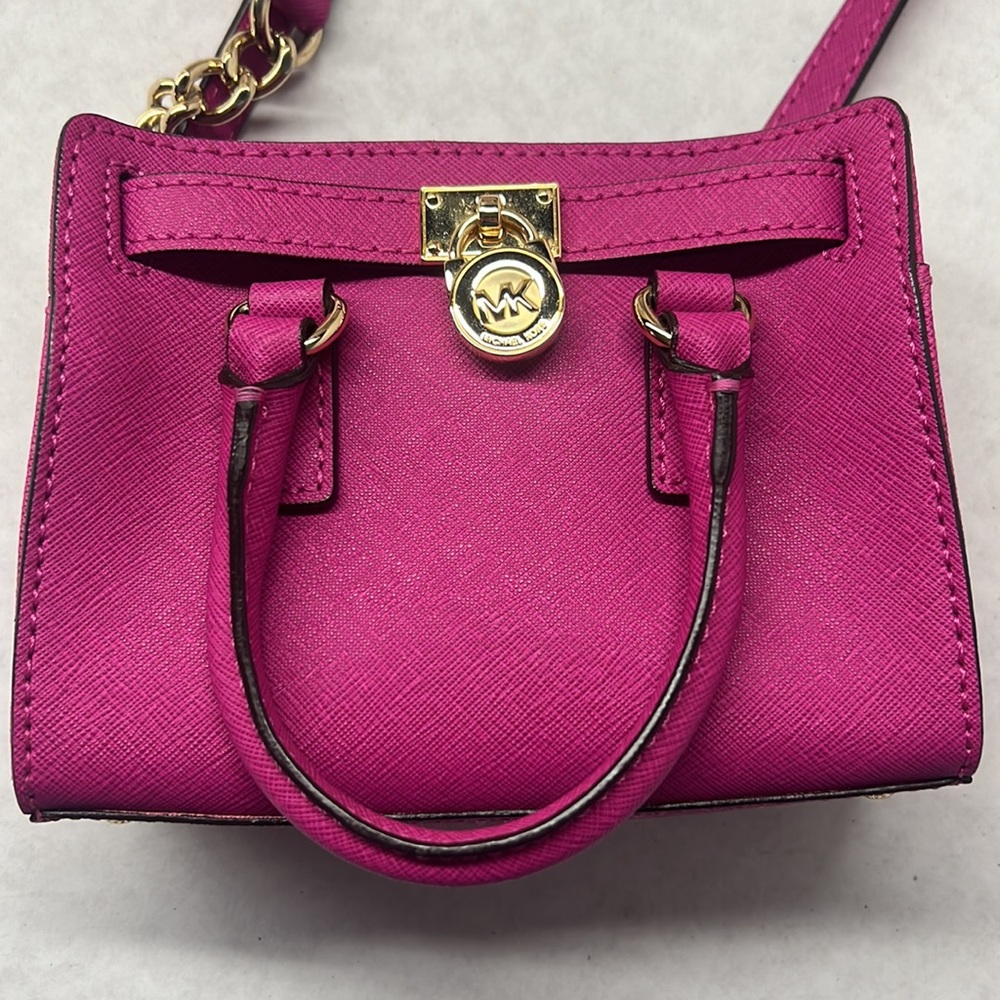 Hot pink mini Michael Kors shoulder bag.